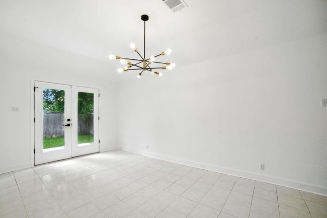 The spacious living room features a cozy gas fireplace and flows seamlessly into a large dining area—perfect for entertaining. | Image 12