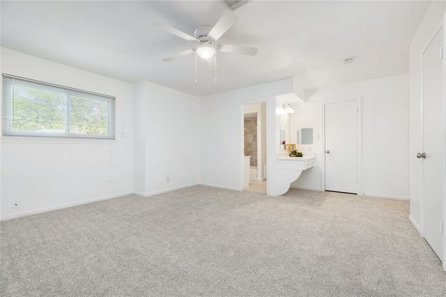 Primary bedroom showing bathroom, vanity, and both closets | Image 25