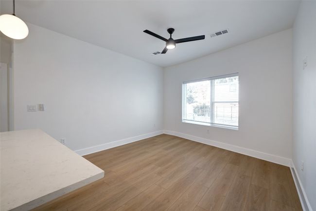 Spare room with a ceiling fan, wood finished floors, and baseboards | Image 7