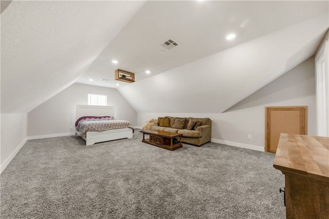 Carpeted bedroom featuring lofted ceiling, baseboards, and recessed lighting | Image 16