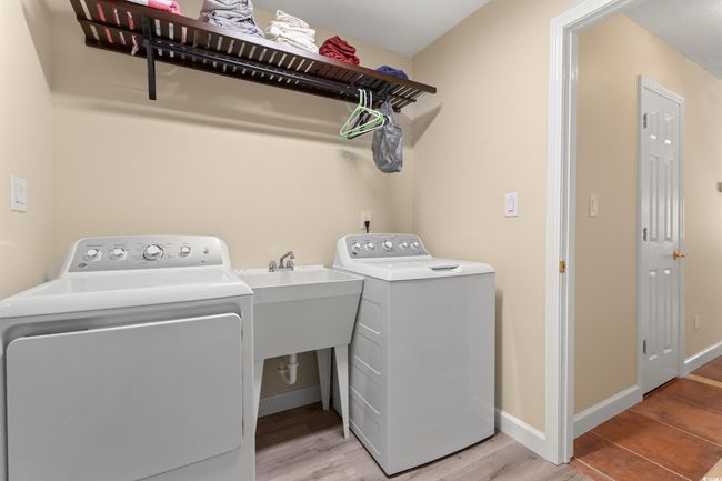 Washroom featuring washer and dryer, light wood-style flooring, and baseboards | Image 26
