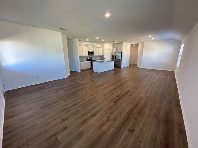 Unfurnished living room featuring recessed lighting, visible vents, and dark wood finished floors | Image 8