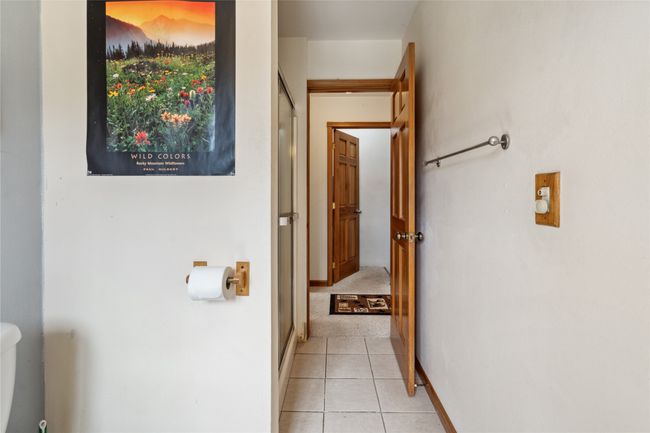 hall to primary bedroom & bathroom, entrance to downstairs | Image 21