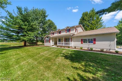 View of front of property featuring covered porch and a front yard | Image 2