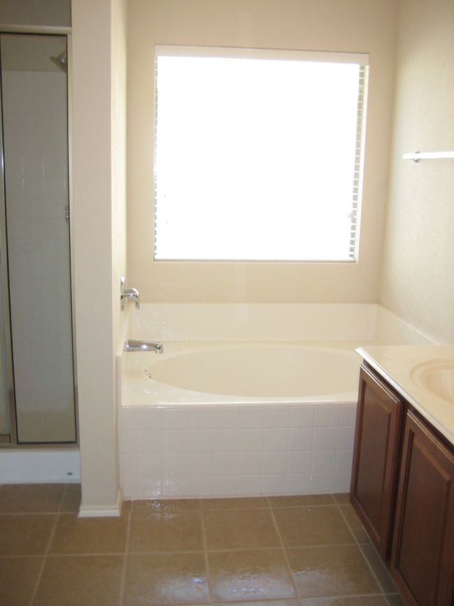 Bathroom featuring plenty of natural light, a bath, and vanity | Image 10
