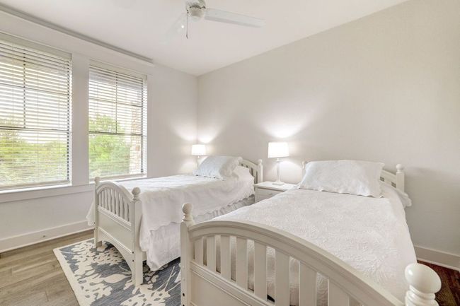 Bedroom with multiple windows, baseboards, and wood finished floors | Image 19