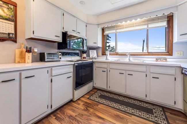 Large Picture Window over looks the beautiful greenery and river. | Image 10