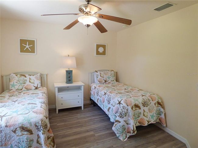 guest bedroom with new vinyl plank flooring, high ceiling, fan | Image 51