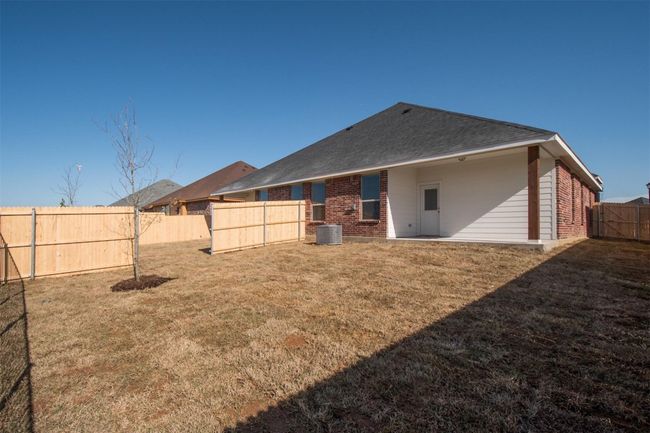Back of house featuring brick siding and central air condition unit | Image 15