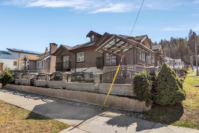 View of front of house featuring a fenced front yard, stucco siding, and a balcony | Image 5