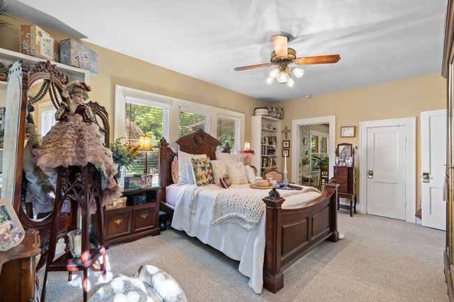 Bedroom with light carpet and a ceiling fan | Image 25