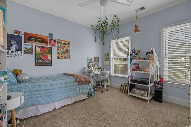 Bedroom with carpet, ornamental molding, multiple windows, and a ceiling fan | Image 30