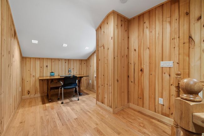 Home office with wooden walls and wood finished floors | Image 33
