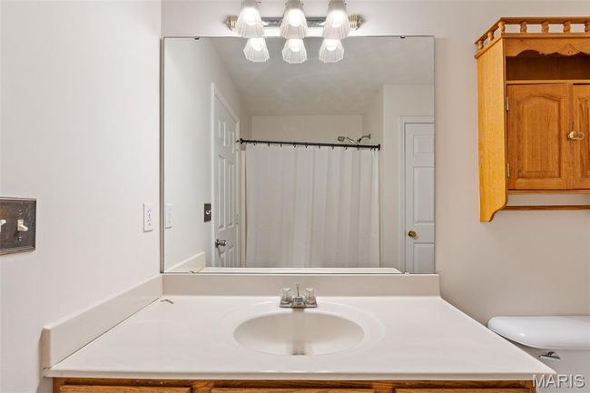 Full bath with vanity, toilet, and a shower with curtain | Image 23