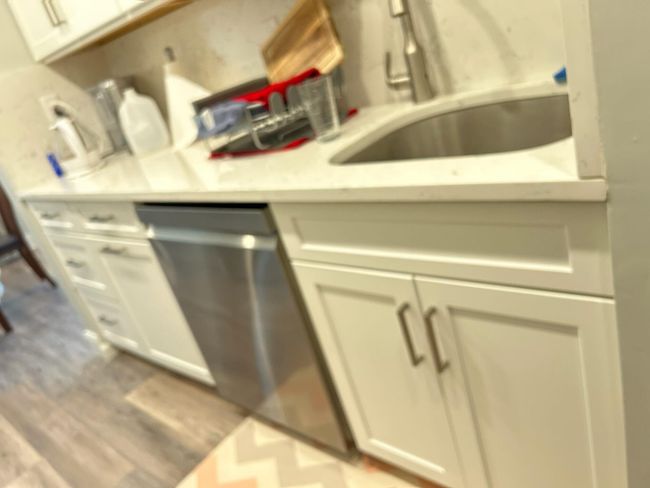 Kitchen featuring a sink, light countertops, light wood-style floors, and white cabinetry | Image 10
