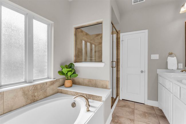 Full bathroom with a garden tub, a stall shower, and vanity | Image 18