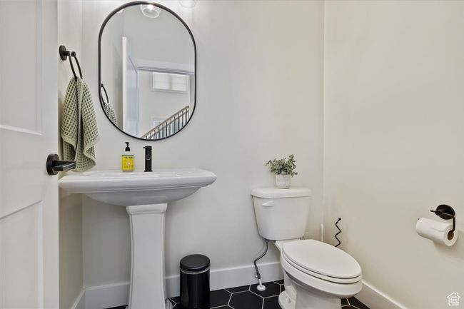 Bathroom with tile patterned floors, baseboards, and toilet | Image 29