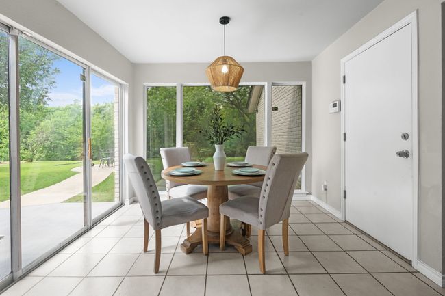 Dining room with plenty of natural light looking out to the beautiful green space | Image 7