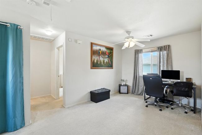 Home office with carpet flooring and a ceiling fan | Image 15