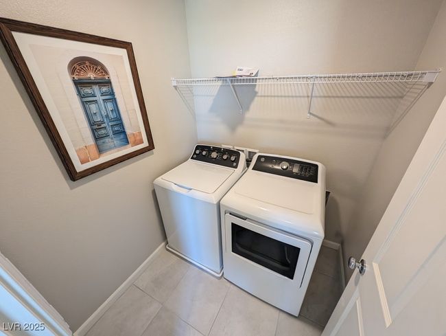 Laundry area with independent washer and dryer and light tile patterned floors | Image 27