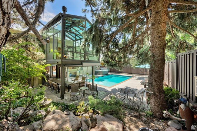 View of pool with a fenced backyard, an outdoor living space, and a patio | Image 24