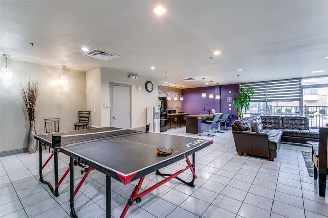 Recreation room with light tile patterned flooring, recessed lighting, and a chandelier | Image 14