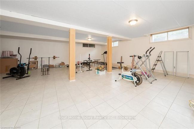 Exercise room featuring tile patterned floors | Image 33