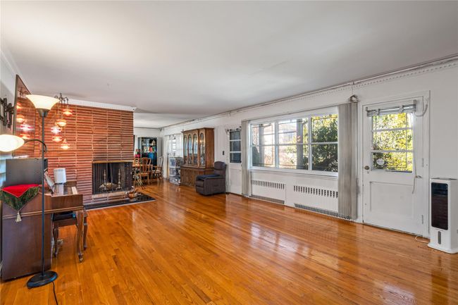 Unfurnished living room with heating unit, radiator heating unit, and a healthy amount of sunlight | Image 10