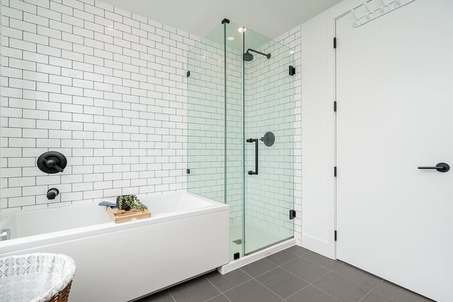Bathroom with a shower stall, a bath, and tile patterned floors | Image 27