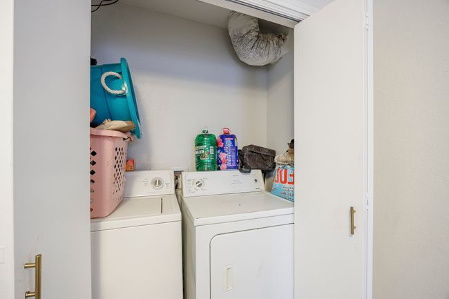 Laundry room featuring laundry area and washing machine and clothes dryer | Image 18