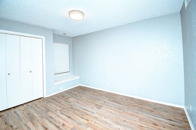 Unfurnished bedroom featuring a textured ceiling, a closet, and light hardwood / wood-style floors | Image 24