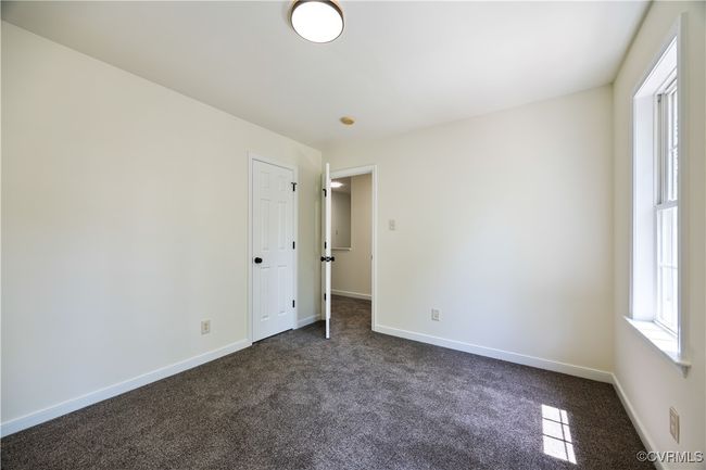 Unfurnished room featuring dark colored carpet and baseboards | Image 26