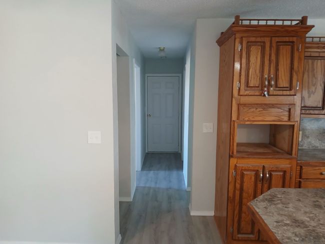 Hall with light hardwood / wood-style floors | Image 10