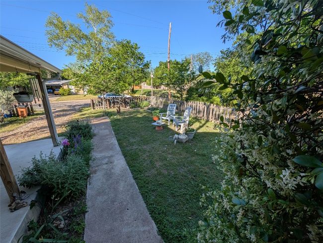 View of yard with fence from front door. | Image 27