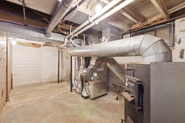 Basement mechanical room with newer (2017) furnace, central AC and a wood stove that can be used for supplemental heating to reduce your heating bills | Image 42