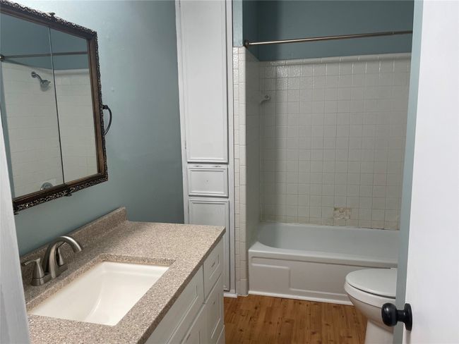 Bathroom featuring shower / bathtub combination, vanity, toilet, and wood finished floors | Image 18