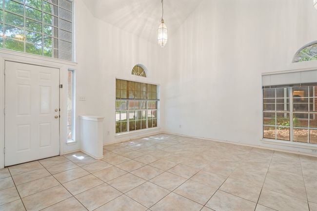 Tiled foyer entrance featuring a towering ceiling and a healthy amount of sunlight | Image 40