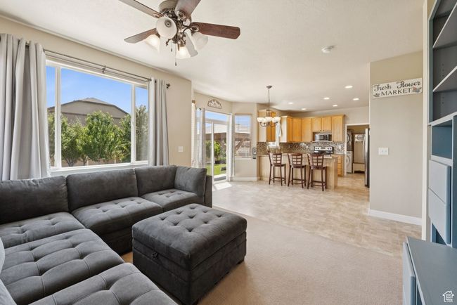 Living area featuring a ceiling fan, recessed lighting, a chandelier, and light colored carpet | Image 11