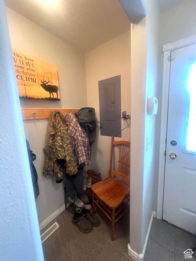 Mudroom featuring baseboards, visible vents, tile patterned flooring, and electric panel | Image 43