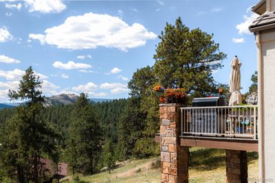 From the interior to the exterior, scenic views unfold in a breathtaking display, stretching from the snow-covered peak of Mount Blue Sky to the rolling hills and lush valleys of the adjacent Elk Meadow Open Space. | Image 3