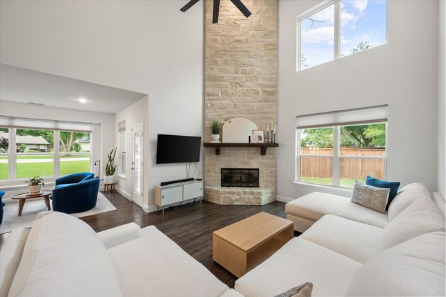Living room has gorgeous wood-burning fireplace with floor-to-ceiling brick facade. | Image 8