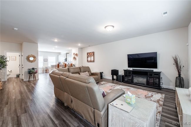 Living room featuring dark wood-type flooring and recessed lighting | Image 6