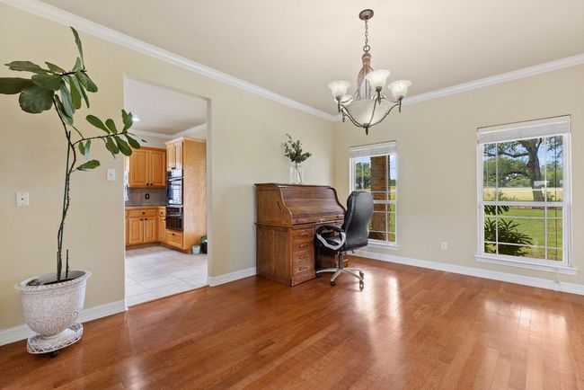 Formal dining room off the main foyer, currently being used as a study. | Image 14