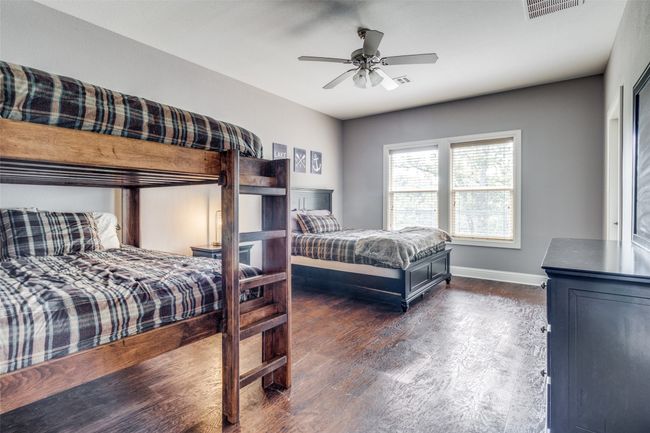 Bedroom with dark wood-type flooring and ceiling fan | Image 20
