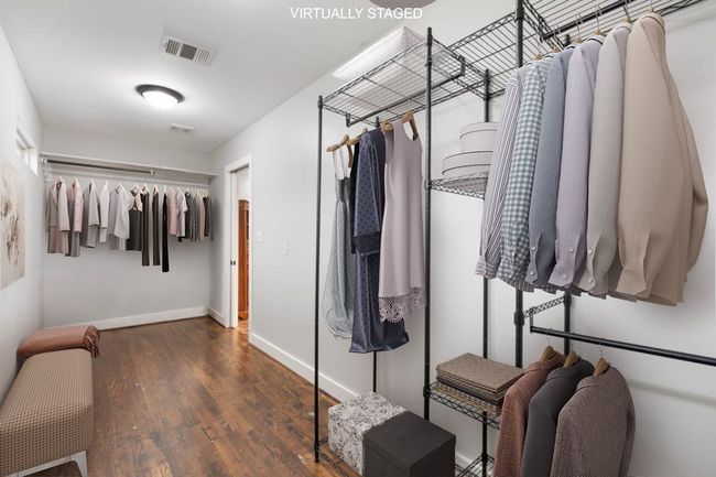 Spacious closet with wood finished floors | Image 38