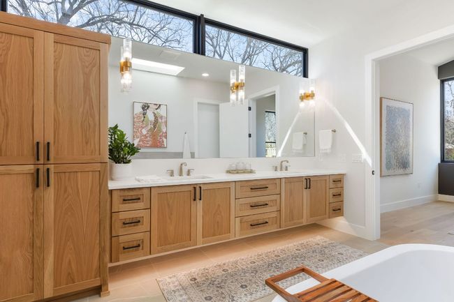 Full bathroom featuring tile patterned flooring, double vanity, a skylight, and a sink | Image 30