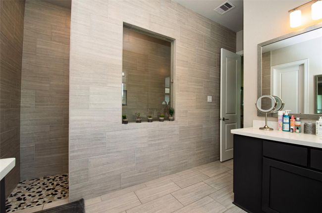Walk-in shower and one of the two vanities. | Image 17