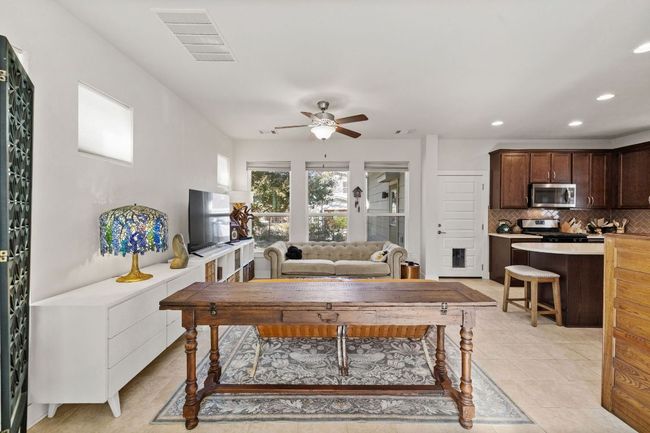 Living room with light tile patterned flooring, visible vents, recessed lighting, and a ceiling fan | Image 7