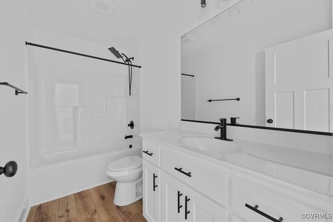 Full bathroom featuring vanity, toilet, bathtub / shower combination, and wood finished floors | Image 24