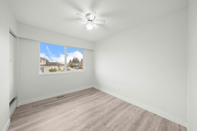 Empty room featuring a ceiling fan, baseboards, light wood finished floors, and visible vents | Image 12